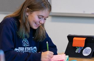 student smiles in class